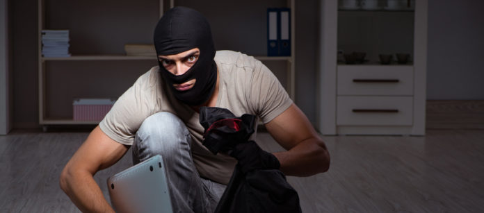 Burglar wearing balaclava mask at crime scene